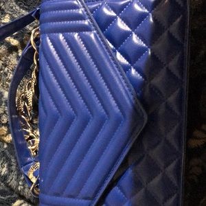 I’m selling a royal blue purse with silver handle.